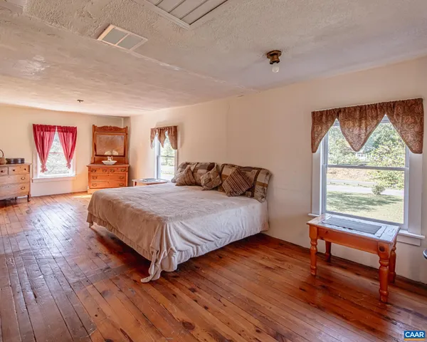 a bedroom with a large bed and a window