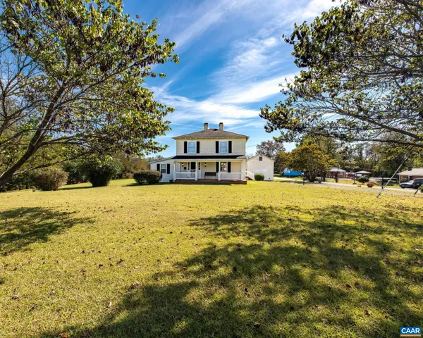 a view of swimming pool with large trees