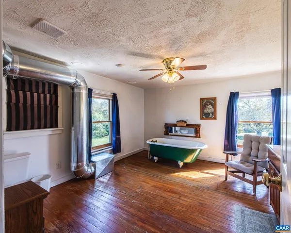a living room with wooden floor and furniture