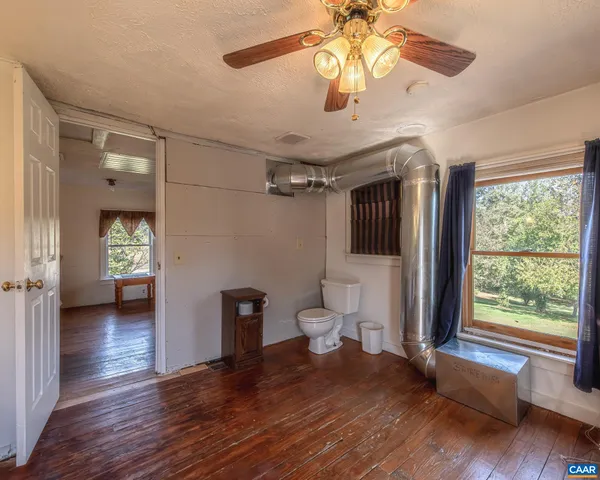 a living room with furniture fireplace and a window