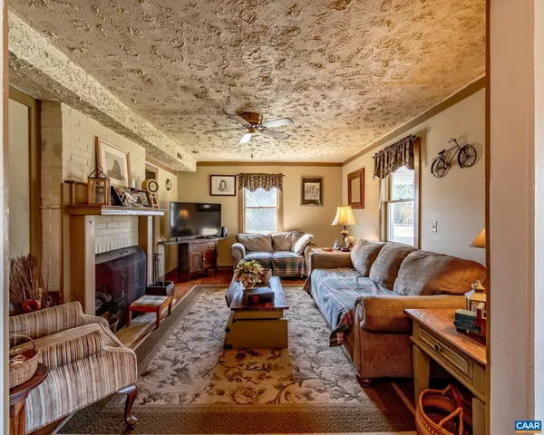 a living room with furniture and a fireplace