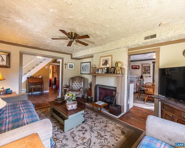 a view of a porch with furniture and wooden floor