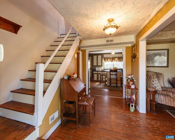 a view of entryway and hall with wooden floor