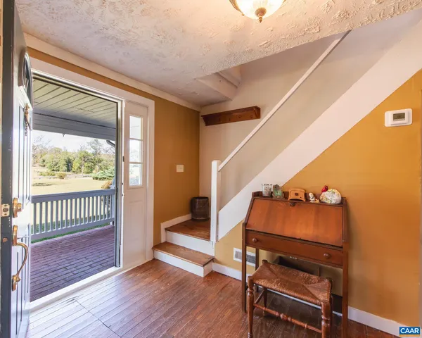 a room with wooden floor and a window