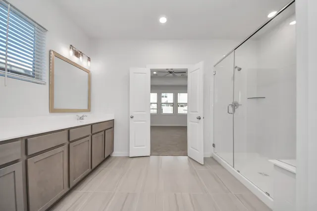 a bathroom with a double vanity sink and mirror
