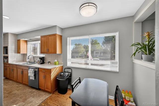 a kitchen with a window a sink and a dining table
