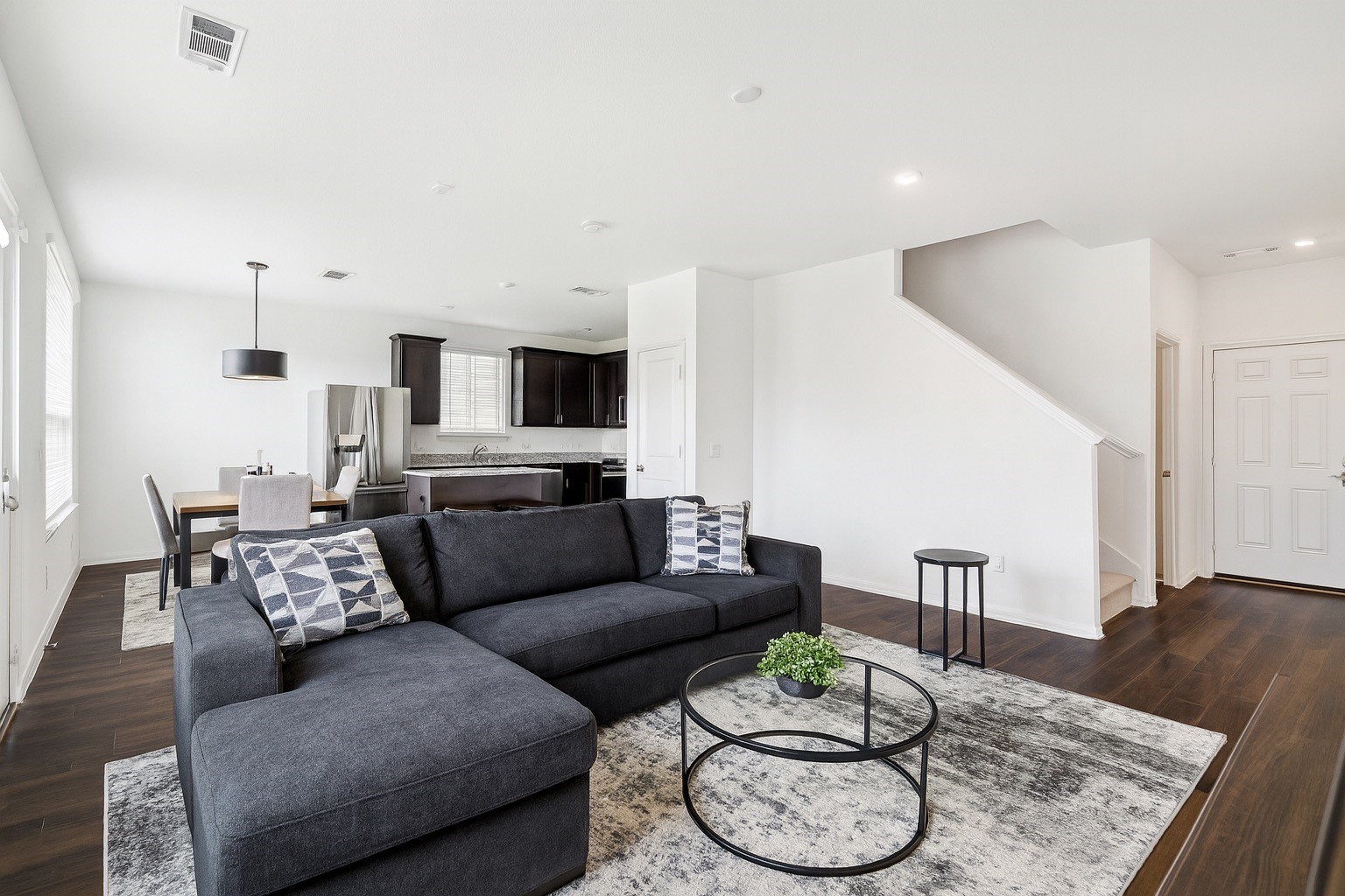 a living room with furniture and wooden floor