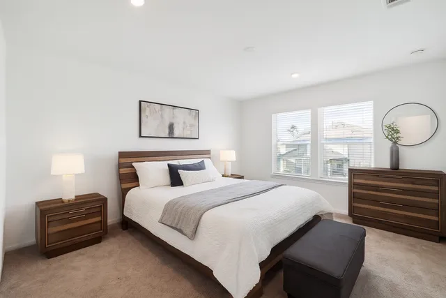 a bedroom with a bed and a painting on the wall