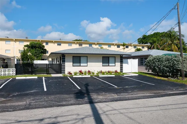 a front view of a house with sitting area