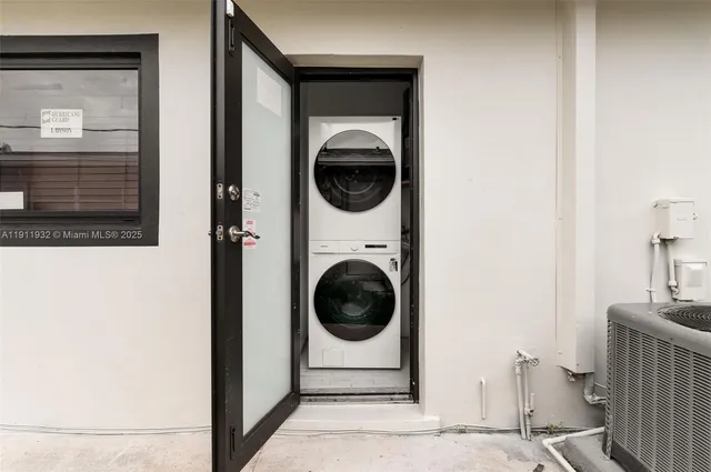 a view of a hallway with washer and dryer