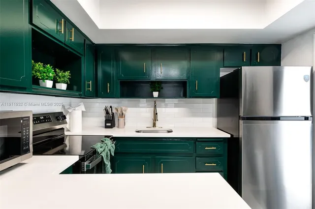 a kitchen with stainless steel appliances a refrigerator and a sink