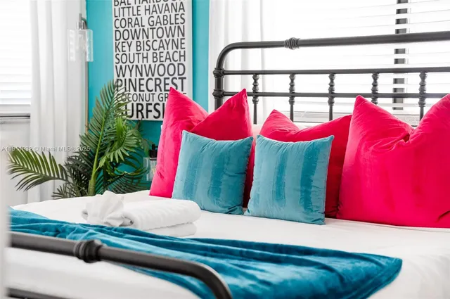 a kitchen with stainless steel appliances a dining table chairs and refrigerator