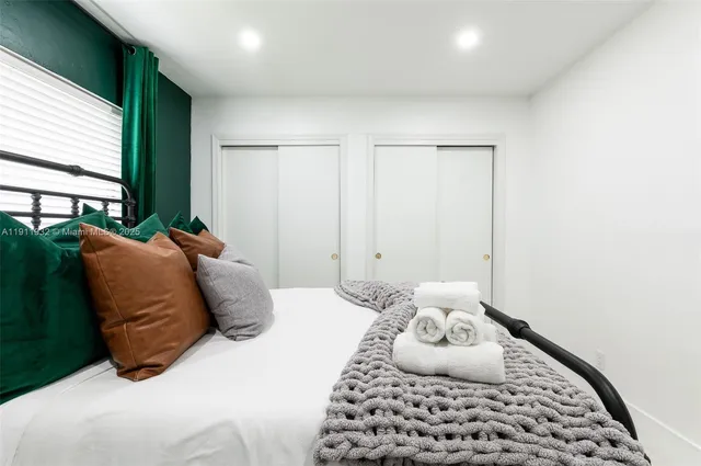 a bedroom with a large bed and a window