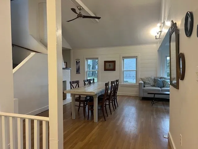 a view of a dining room with furniture and wooden floor