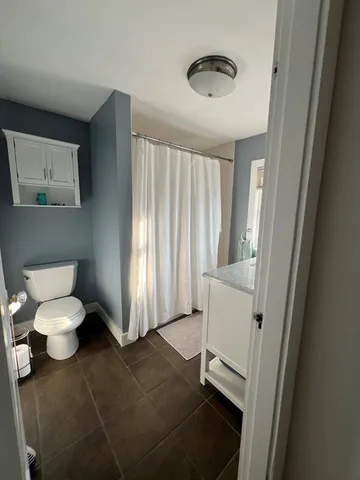 a bathroom with a toilet sink and tub
