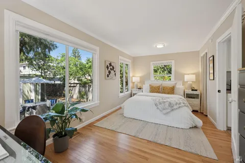 a bedroom with bed and glass windows