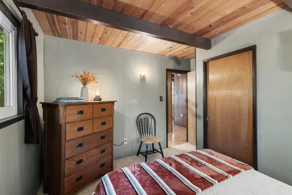 a bedroom with a bed and a dresser