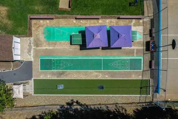 a swimming pool with trees in the background