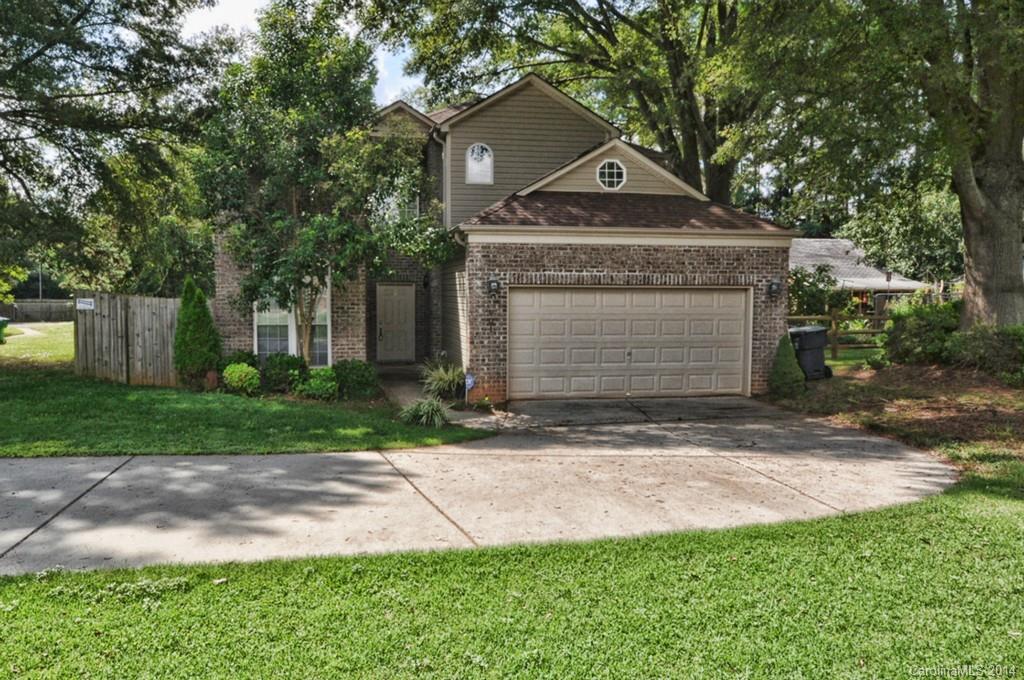 901 McAlway Road Charlotte, NC 28211 - Photo 1 of 24 a front view of a house with a garden and trees