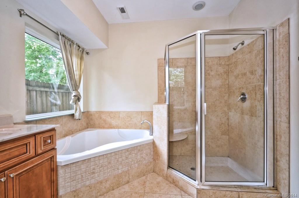 901 McAlway Road Charlotte, NC 28211 - Photo 19 of 24 a bathroom with a bathtub shower and window