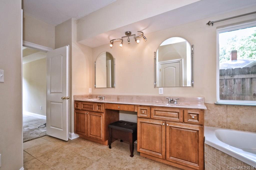 901 McAlway Road Charlotte, NC 28211 - Photo 20 of 24 a bathroom with a double vanity sink a mirror a bathtub and