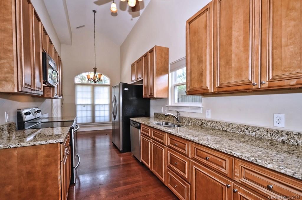901 McAlway Road Charlotte, NC 28211 - Photo 3 of 24 a kitchen with stainless steel appliances granite countertop a sink a stove and a wooden floors