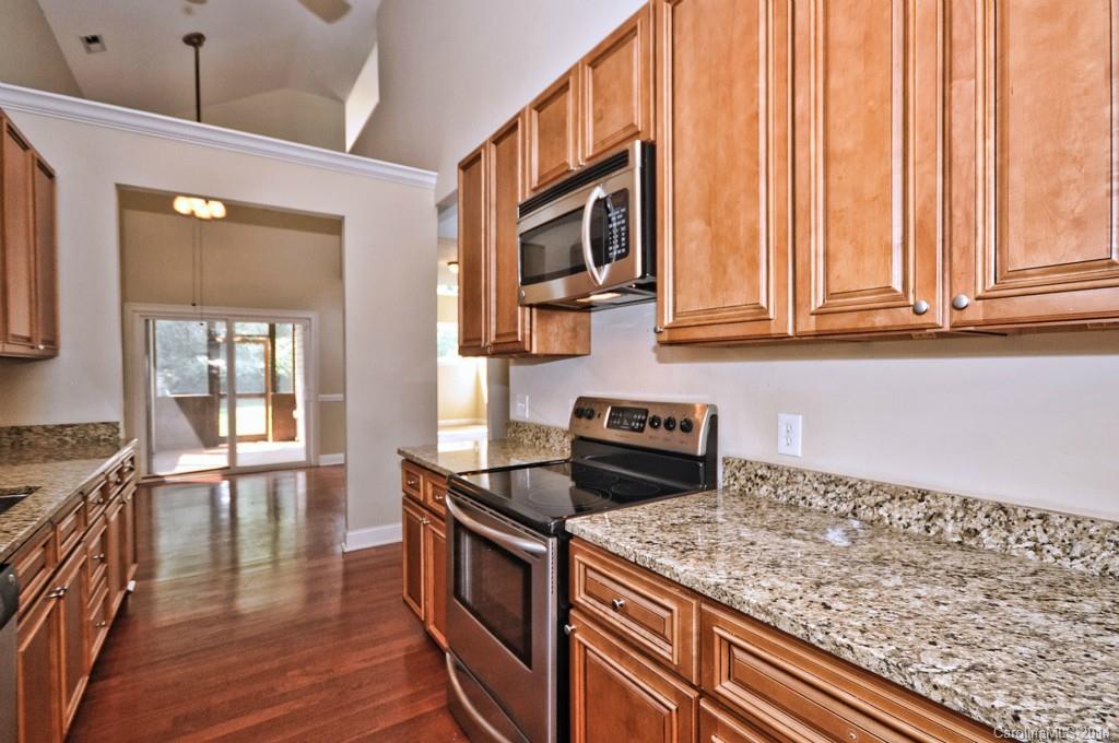 901 McAlway Road Charlotte, NC 28211 - Photo 5 of 24 a kitchen with stainless steel appliances granite countertop a stove and a wooden cabinets