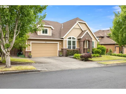 a front view of a house with a yard and garage