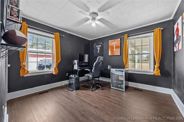 a view of a workspace with furniture and a window