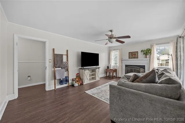 a living room with furniture flat screen tv and a fireplace