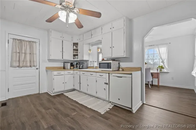 a kitchen with white cabinets and white appliances