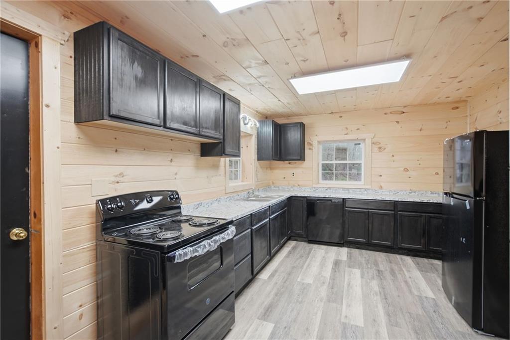 1780 Conasauga Road Ellijay, GA 30540 - Photo 26 of 43 a kitchen with granite countertop stainless steel appliances and wooden cabinets