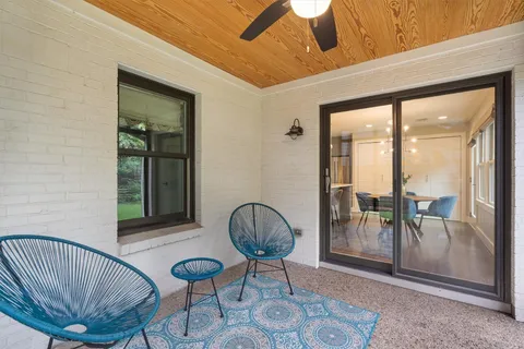 a kitchen with stainless steel appliances a table and chairs in it