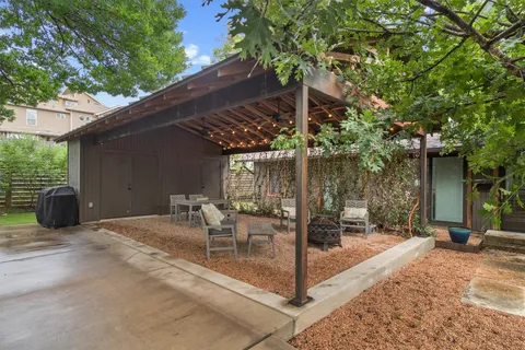 a living room with furniture and a grill