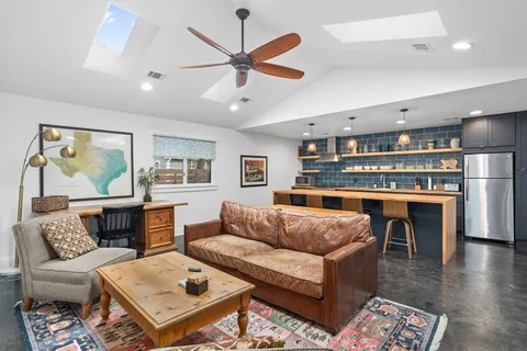 a kitchen with a dining table chairs and wooden floor