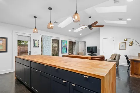 a spacious bedroom with a bed and a ceiling fan