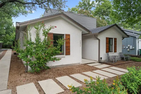 a view of a patio with table and chairs and potted plants