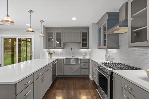 a kitchen with stainless steel appliances granite countertop a stove and a sink