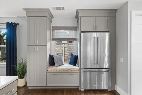 a kitchen with a stove a sink a dining table and chairs