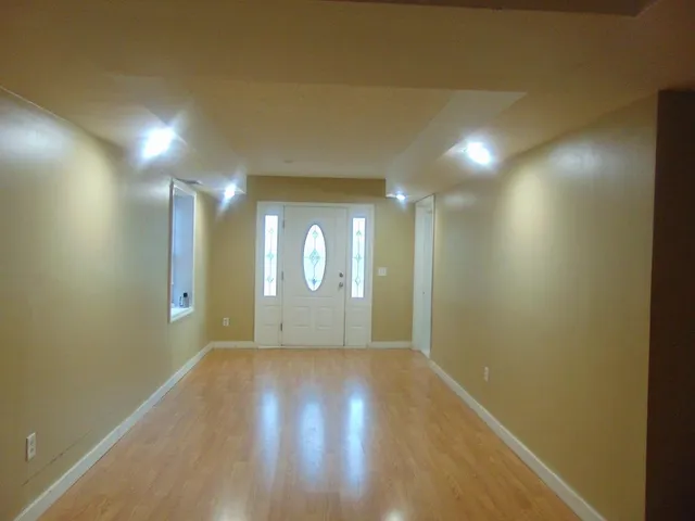 a view of a hallway with wooden floor