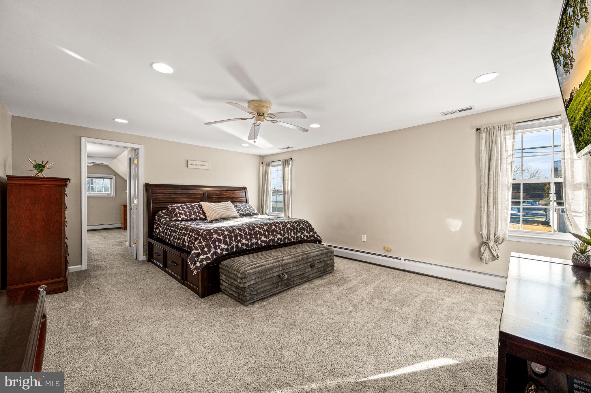 29 Spindletree Road Levittown, PA 19056 - Photo 19 of 29 a spacious bedroom with a bed and a flat screen tv