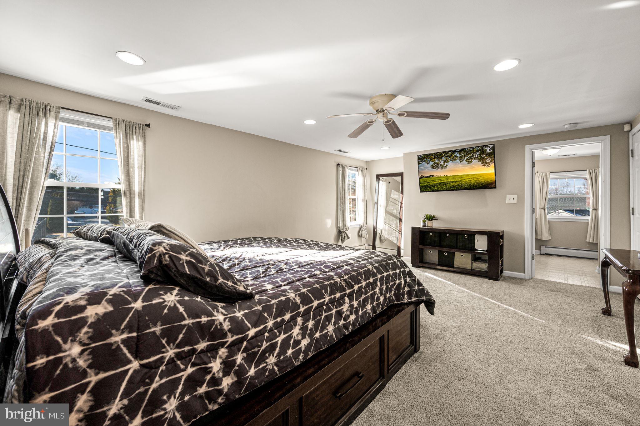 29 Spindletree Road Levittown, PA 19056 - Photo 20 of 29 a bedroom with a bed and a fireplace