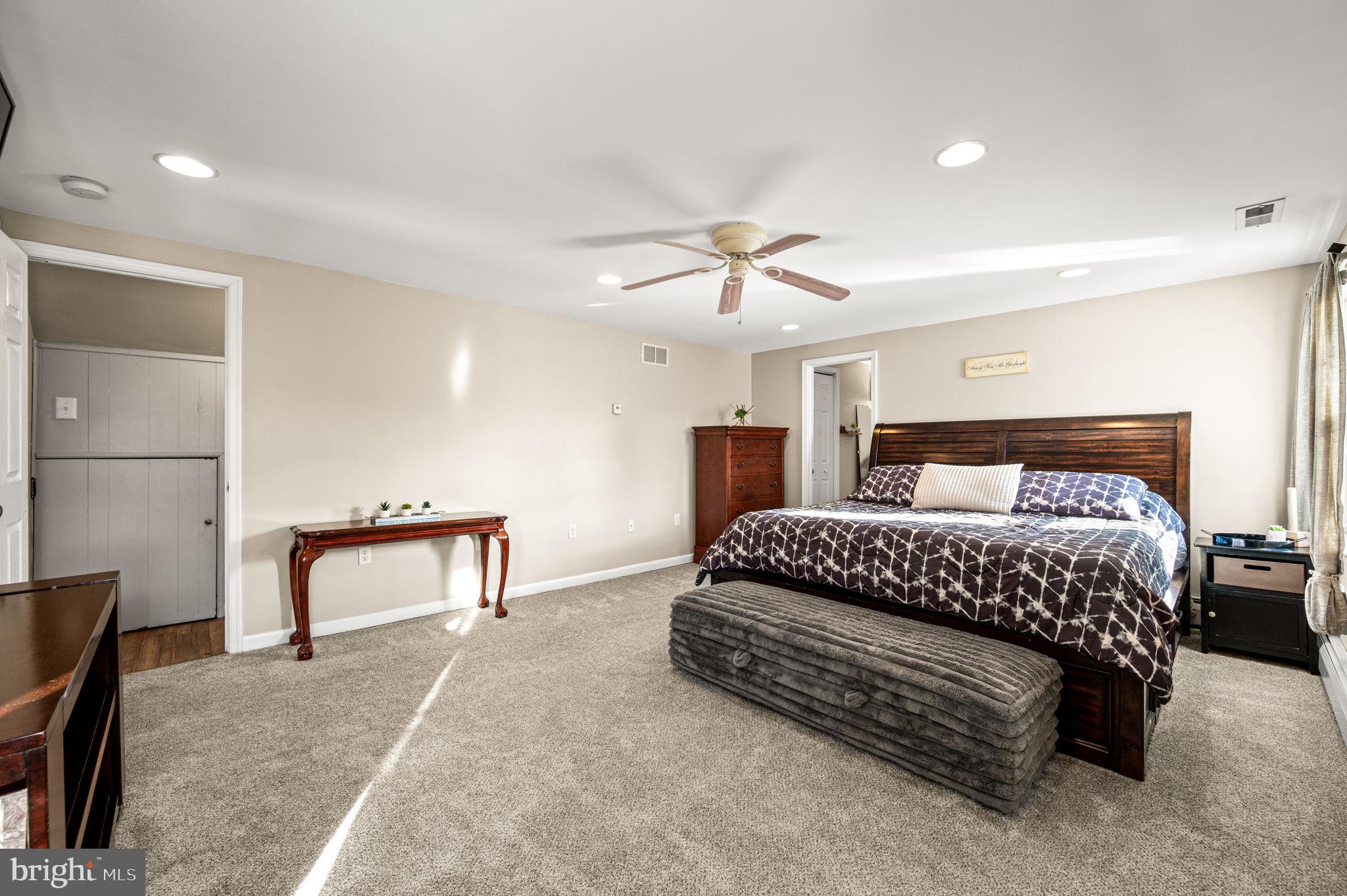 29 Spindletree Road Levittown, PA 19056 - Photo 21 of 29 a bedroom with a bed and a chandelier