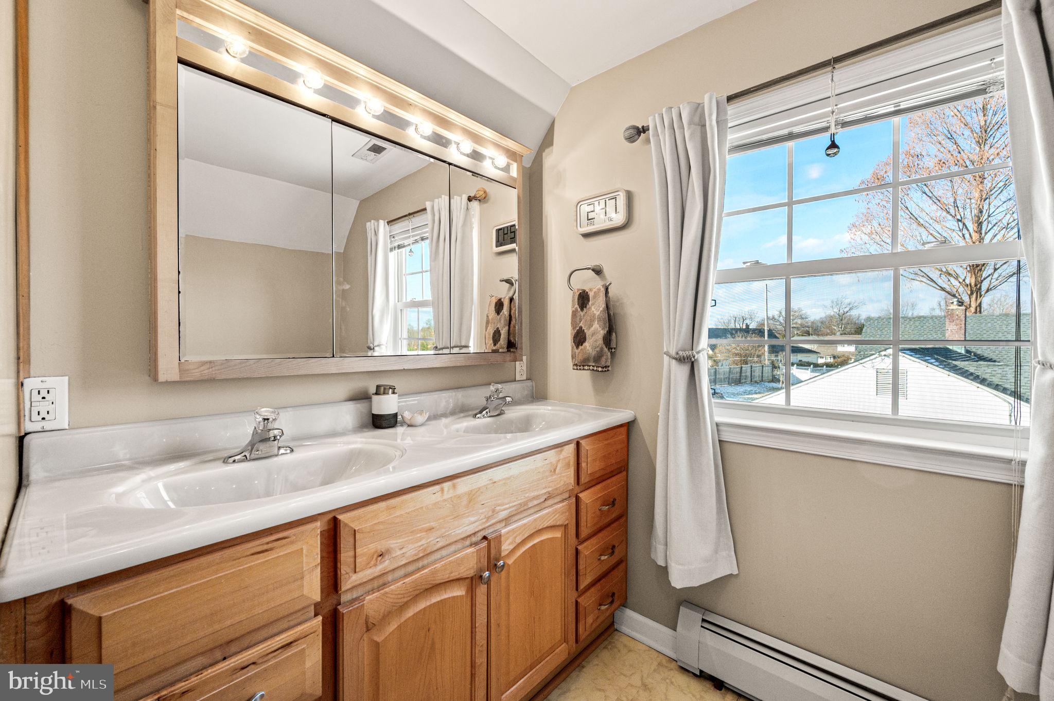 29 Spindletree Road Levittown, PA 19056 - Photo 22 of 29 a bathroom with a sink and a mirror