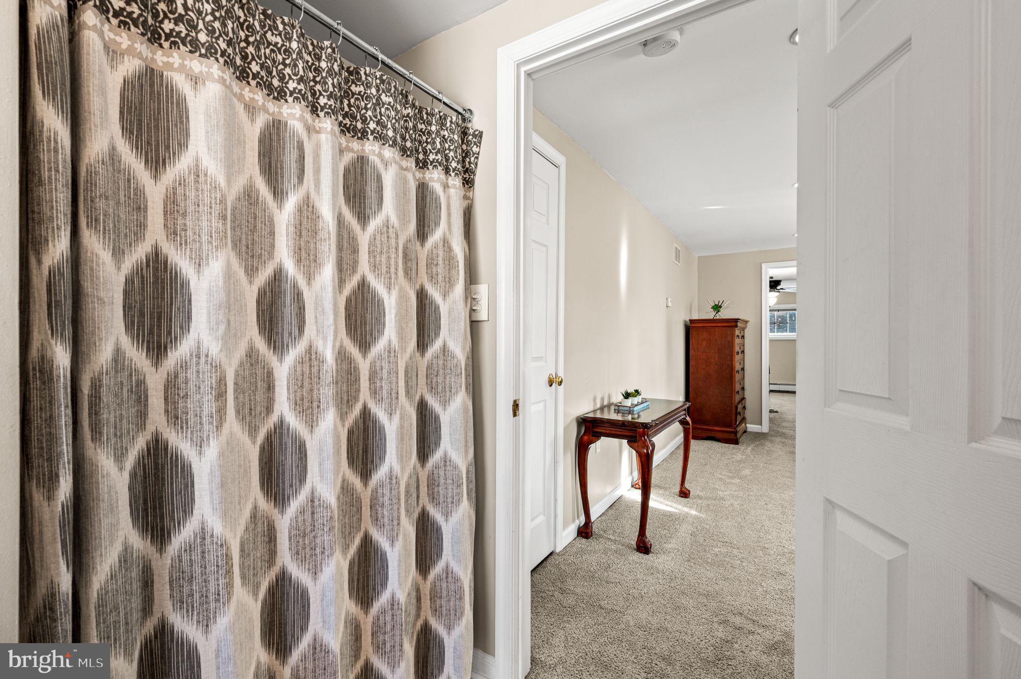 29 Spindletree Road Levittown, PA 19056 - Photo 23 of 29 a view of a hallway with chairs and a large window
