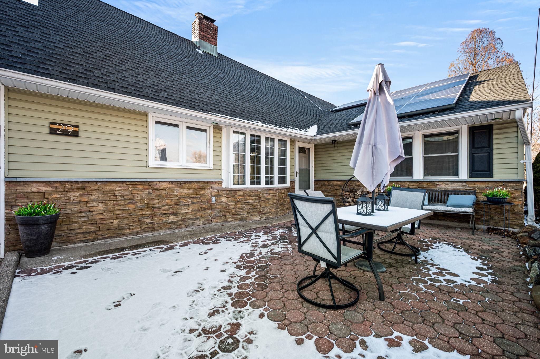 29 Spindletree Road Levittown, PA 19056 - Photo 27 of 29 a backyard of a house with table and chairs