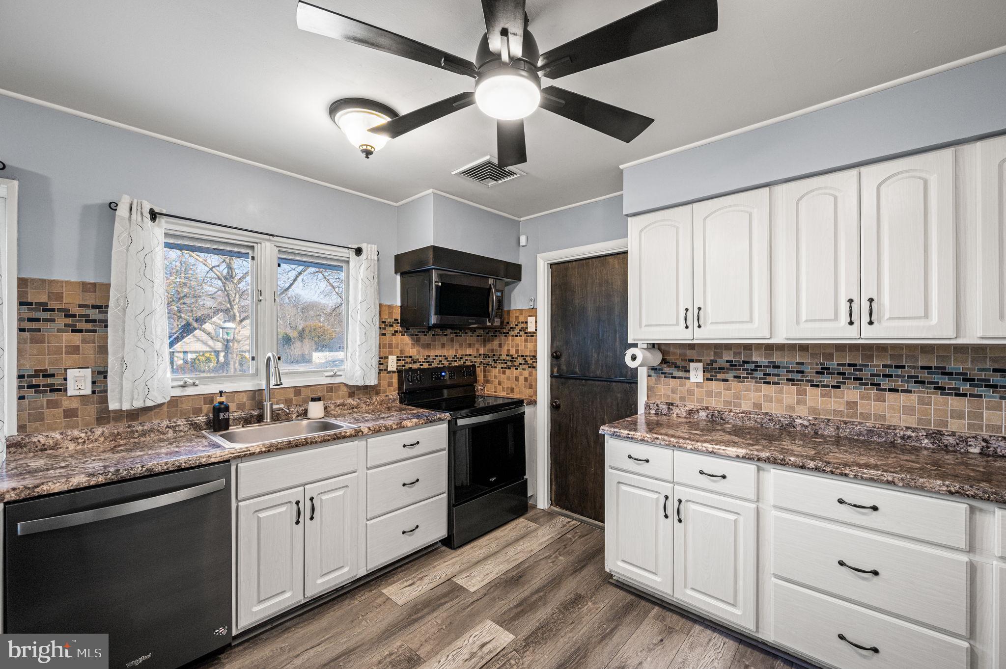 29 Spindletree Road Levittown, PA 19056 - Photo 9 of 29 a kitchen with a stove window and cabinets