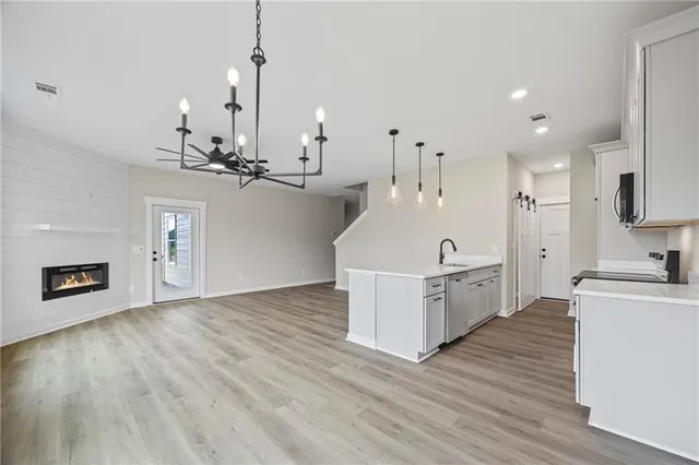 a large kitchen with sink a microwave a stove and refrigerator