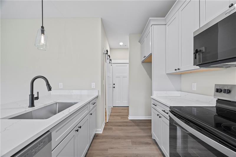 613 Racetrack Road Toccoa, GA 30577 - Photo 19 of 47 a kitchen with stainless steel appliances granite countertop a sink and a stove