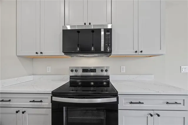 a stove top oven sitting inside of a kitchen